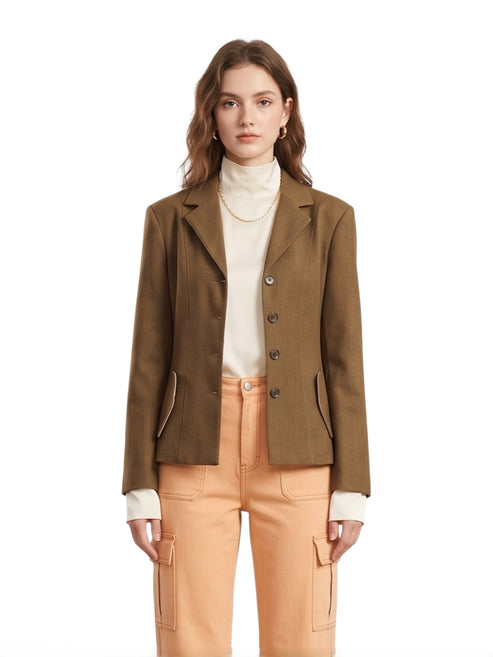 Woman wearing a brown blazer and apricot jeans on a white background front view