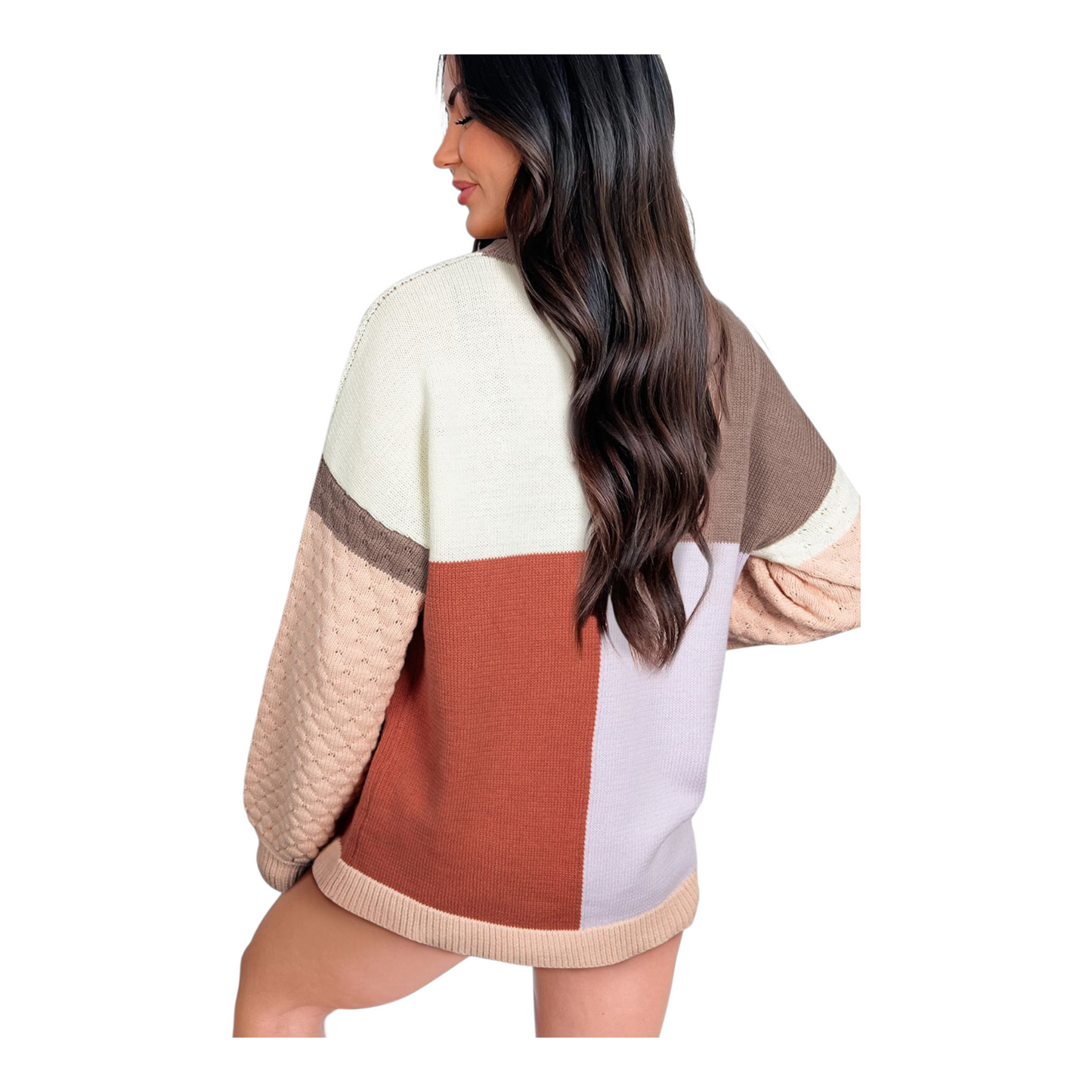 Woman wearing a color-blocked sweater with a neutral background