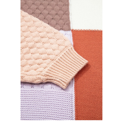 Close-up of a textured fabric with a patterned edge on a white background