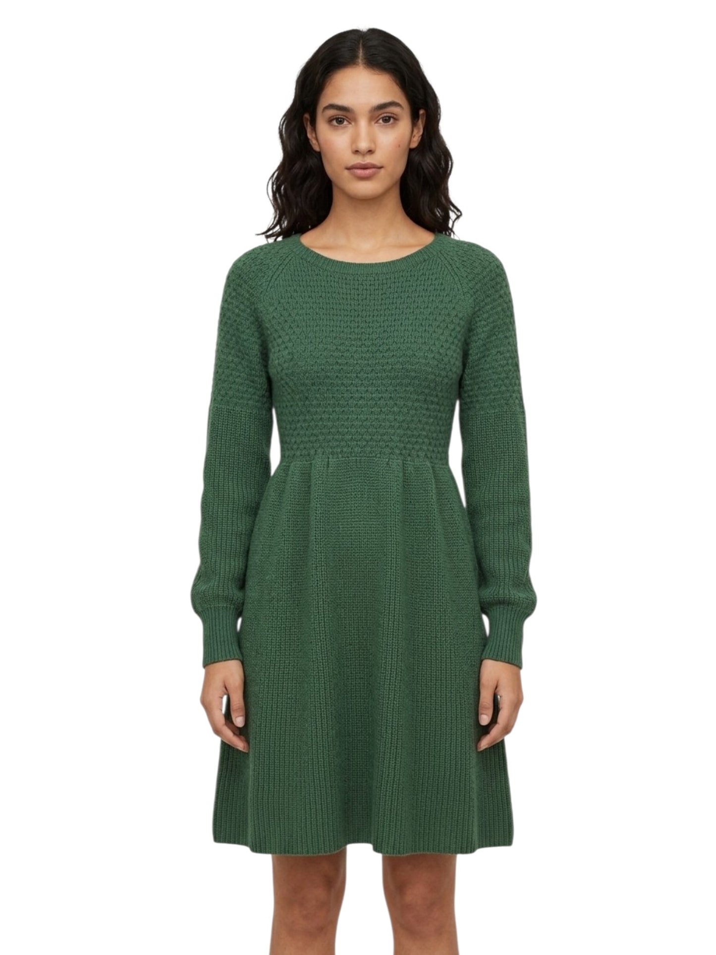 A woman modeling a green long-sleeve knit dress with a textured pattern, standing against a plain white background.