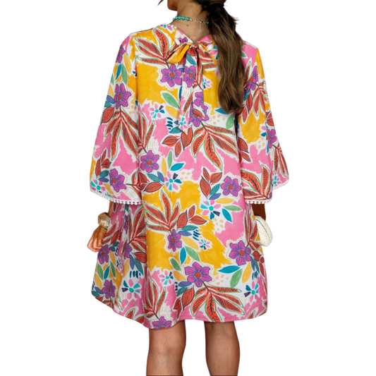 Colorful floral dress worn by a person on a white background