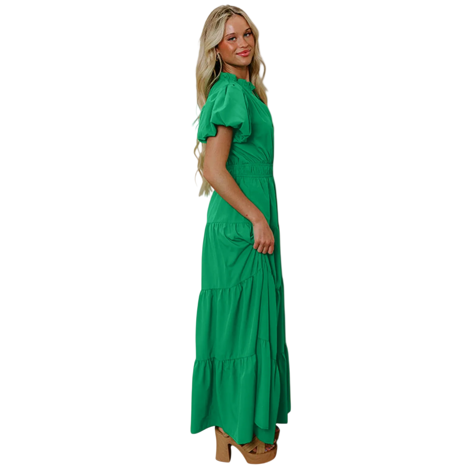 Side view of a woman wearing a vibrant green tiered maxi dress with short puff sleeves, a flattering V-neckline, and an elongated high-waist silhouette.