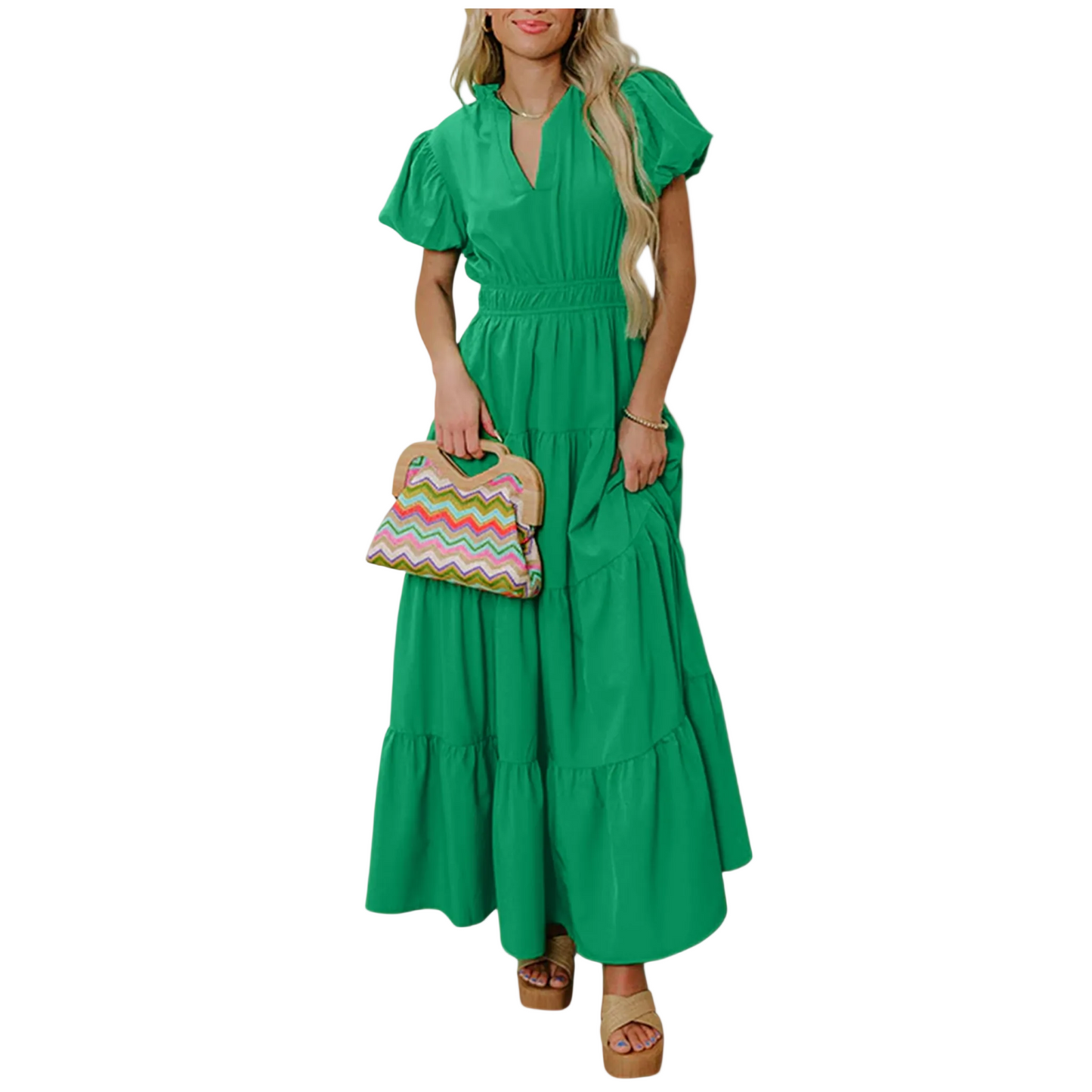 A woman wearing a vibrant green tiered maxi dress with short puff sleeves, a flattering V-neckline, and an elongated high-waist silhouette.