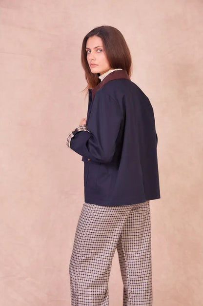 Rear profile of the navy Valerie jacket showing the structured cotton fabric and relaxed hip-length fit.