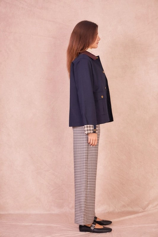 Side profile of the navy Valerie jacket showing the structured cotton fabric and relaxed hip-length fit.