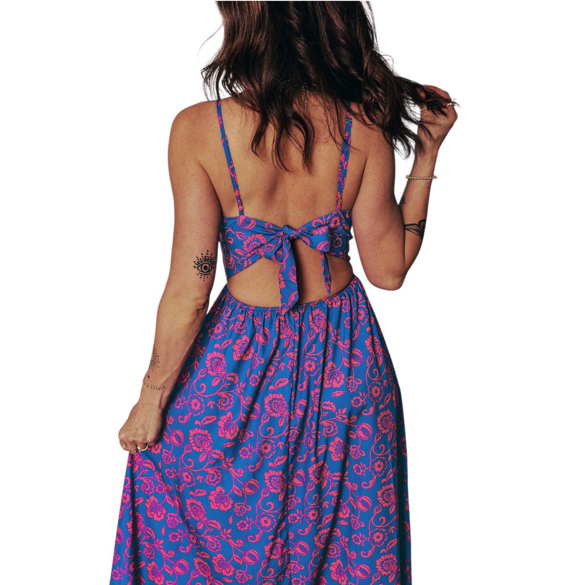 Half rear view of a backless floral summer dress featuring an elegant tie-back bow detail and a flowy A-line maxi skirt.