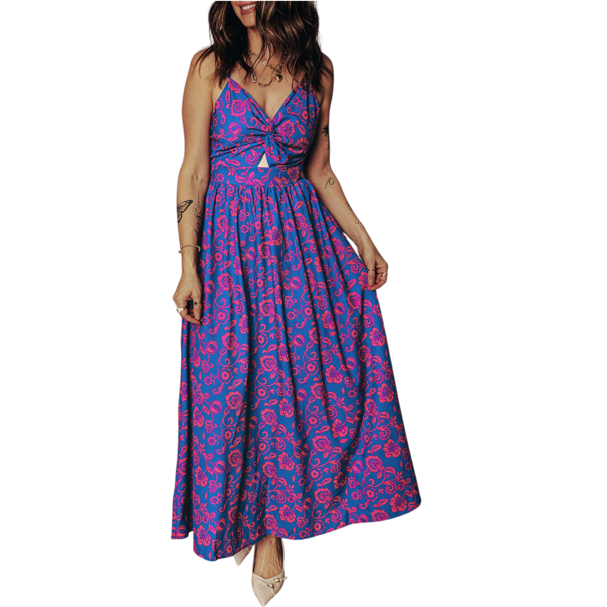 Model wearing a flowy floral maxi dress with a twisted bodice and adjustable spaghetti straps, showcasing the movement of the cobalt blue fabric.