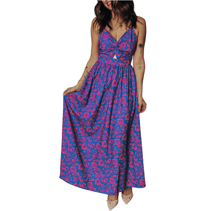Model wearing a flowy floral maxi dress with a twisted bodice and adjustable spaghetti straps, showcasing the movement of the cobalt blue fabric.