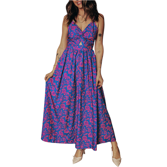 Front view of a vibrant cobalt blue maxi dress featuring a pink floral print, twisted V-neckline, and waist cut-out on a clean white background.
