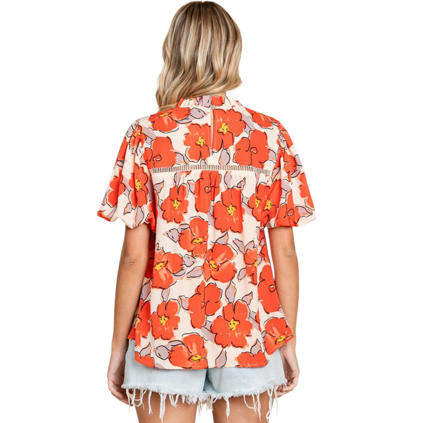 Rear view of a bohemian-style floral blouse featuring a keyhole back and oversized bubble sleeves.
