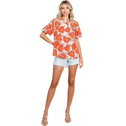Full front view of a vibrant floral print blouse with bubble sleeves and a ruffle high-neck collar.