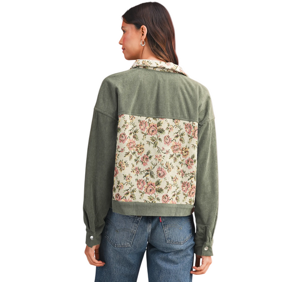 Back view of a woman wearing the green floral patchwork corduroy jacket highlighting the large tapestry center panel.