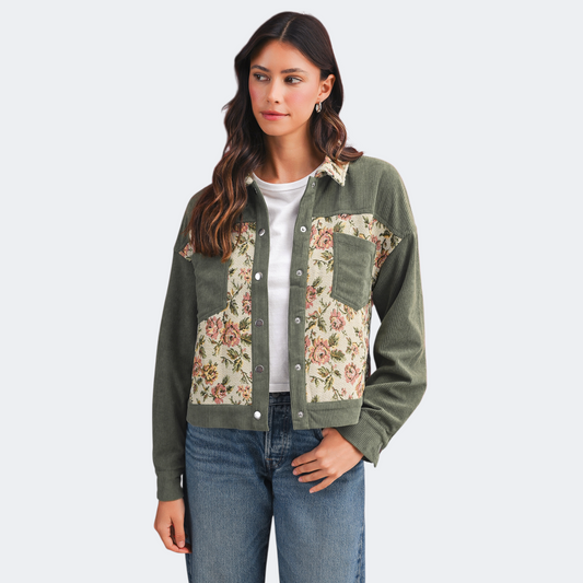 Sage green corduroy jacket on a model featuring floral tapestry patchwork panels and two front pockets.
