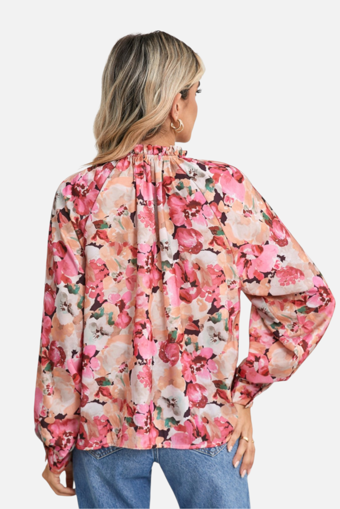 Woman wearing a floral blouse with long sleeves on a white background
