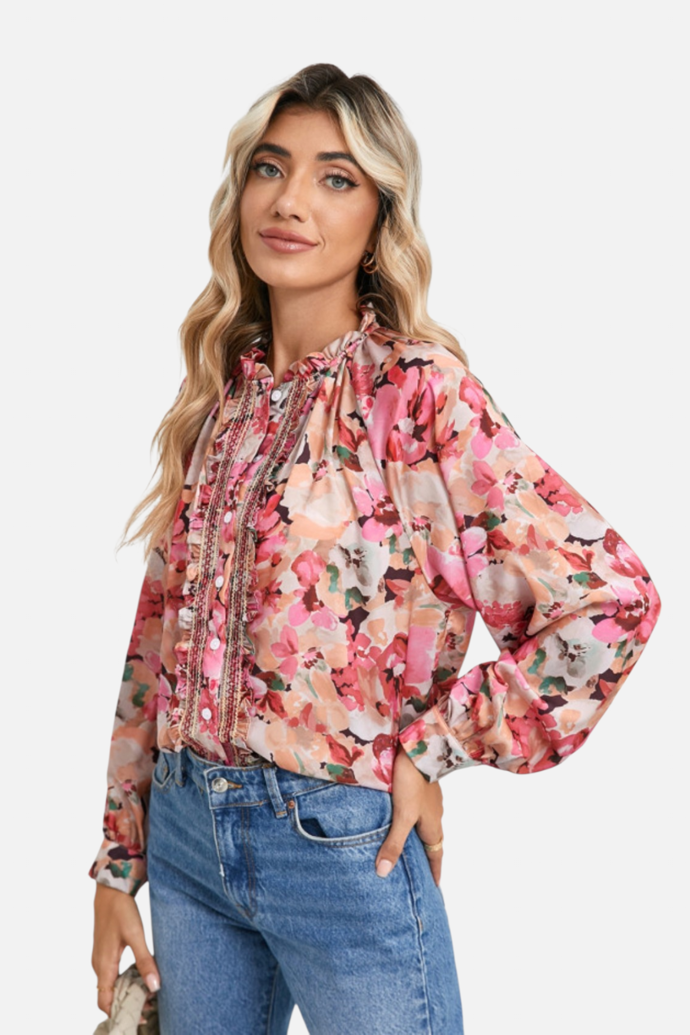 Woman wearing a floral blouse and jeans on a white background