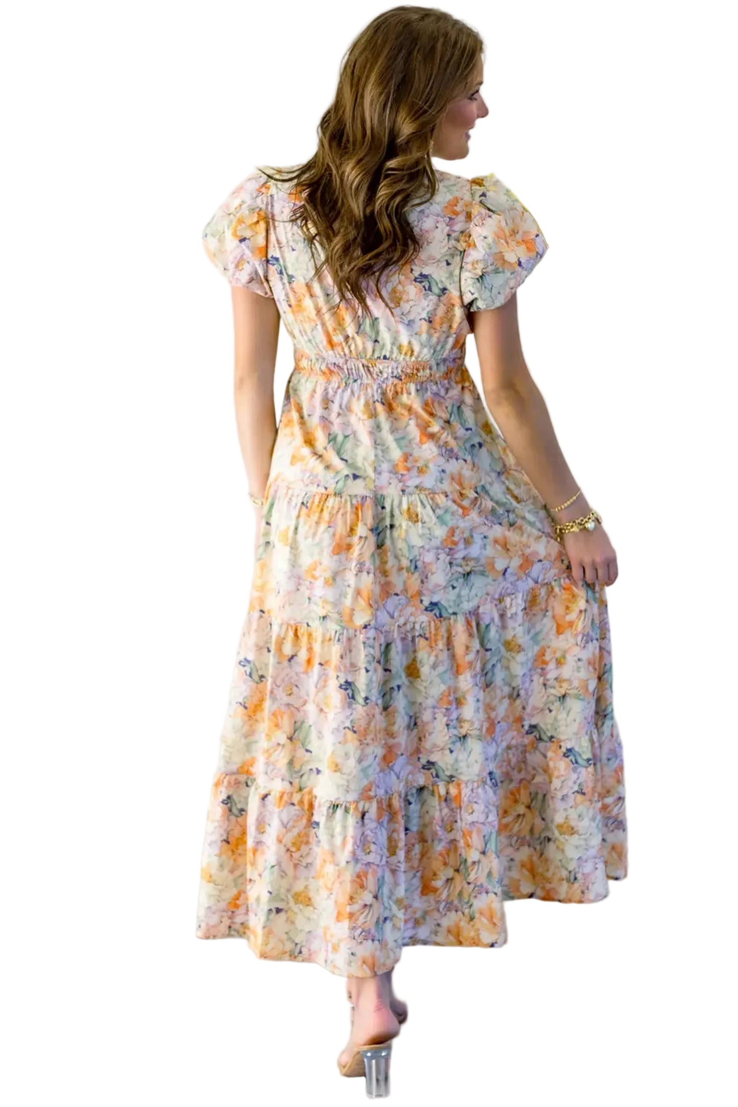 Rear view of the model displaying the pattern continuation and the fluid drape of the tiered longline holiday dress.