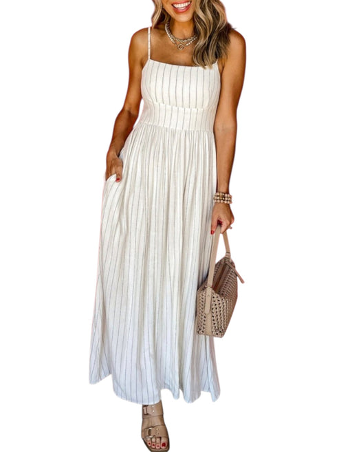 Woman wearing a white striped pleated dress holding a straw bag on a white background front view