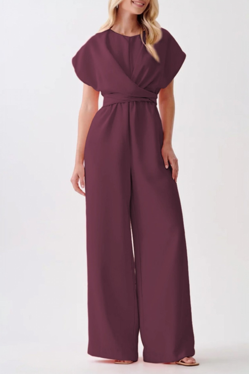 A model showcasing a formal plum jumpsuit with an elegant wide-leg cut, cinched waist, and minimalist round neckline.