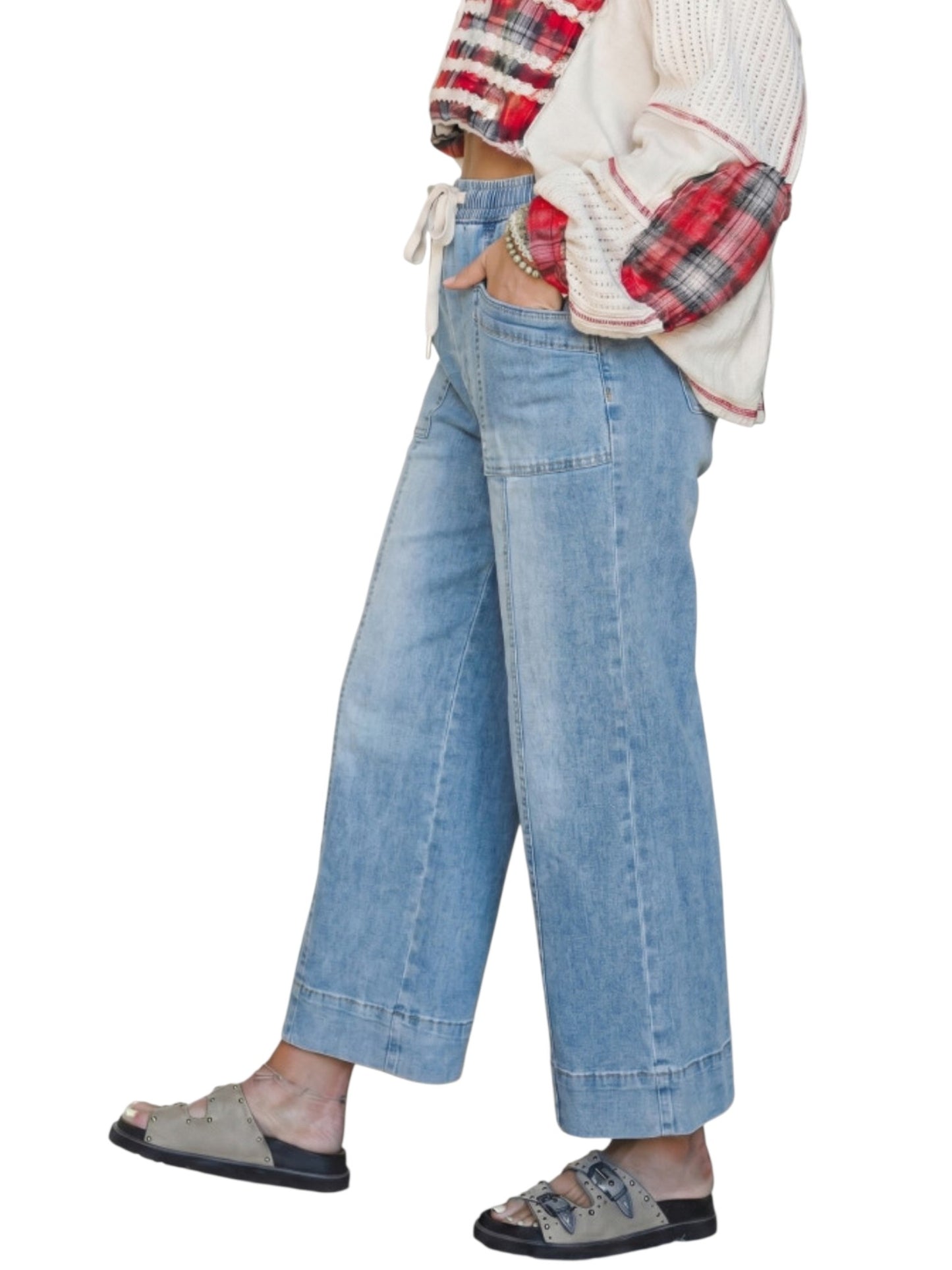 Wide leg drawstring denim jeans on model side view against a white neutral background