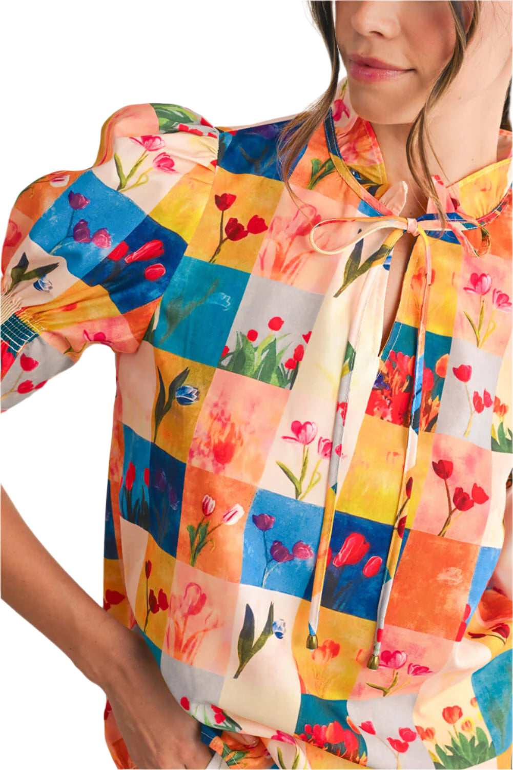 Focus view on a design of a floral checked  blouse with short sleeves, perfect for summer outings.