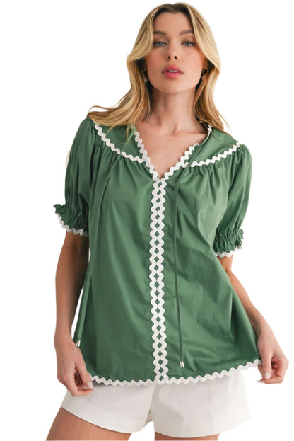 Relaxed-fit Mist Green V-Neck blouse paired with summer white shorts.