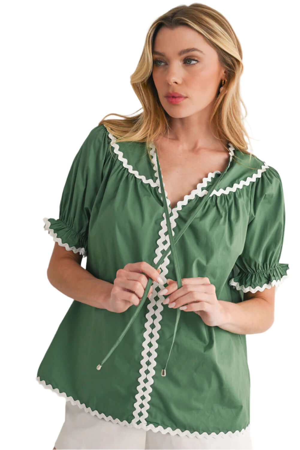 Model wearing Mist Green blouse with puff sleeves and feminine ricrac detailing.