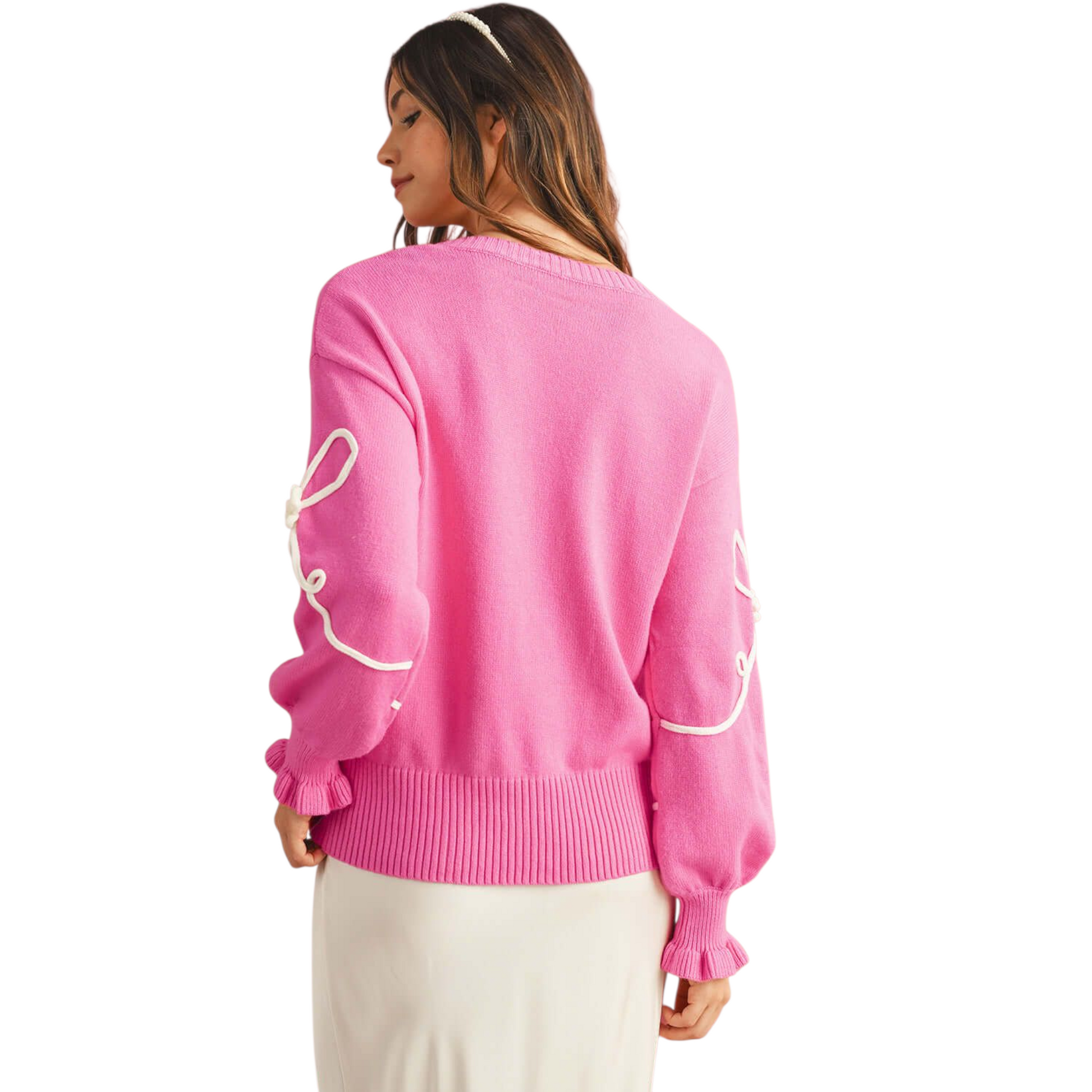 Person wearing a pink sweater with white text on a white background