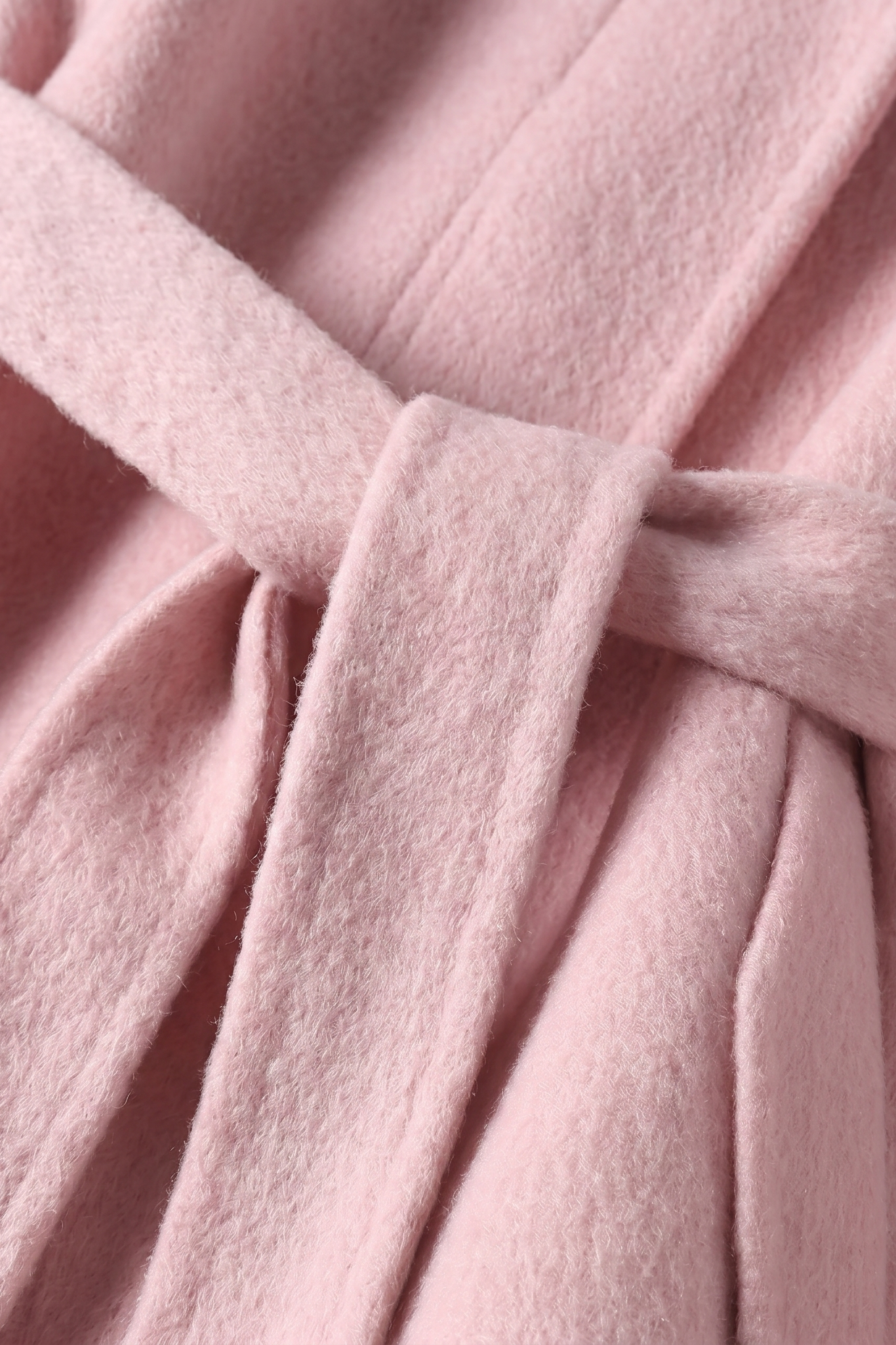 Detailed shot of the matching rose wool self-tie belt, showcasing the thick, premium texture of the double-faced wool fabric.