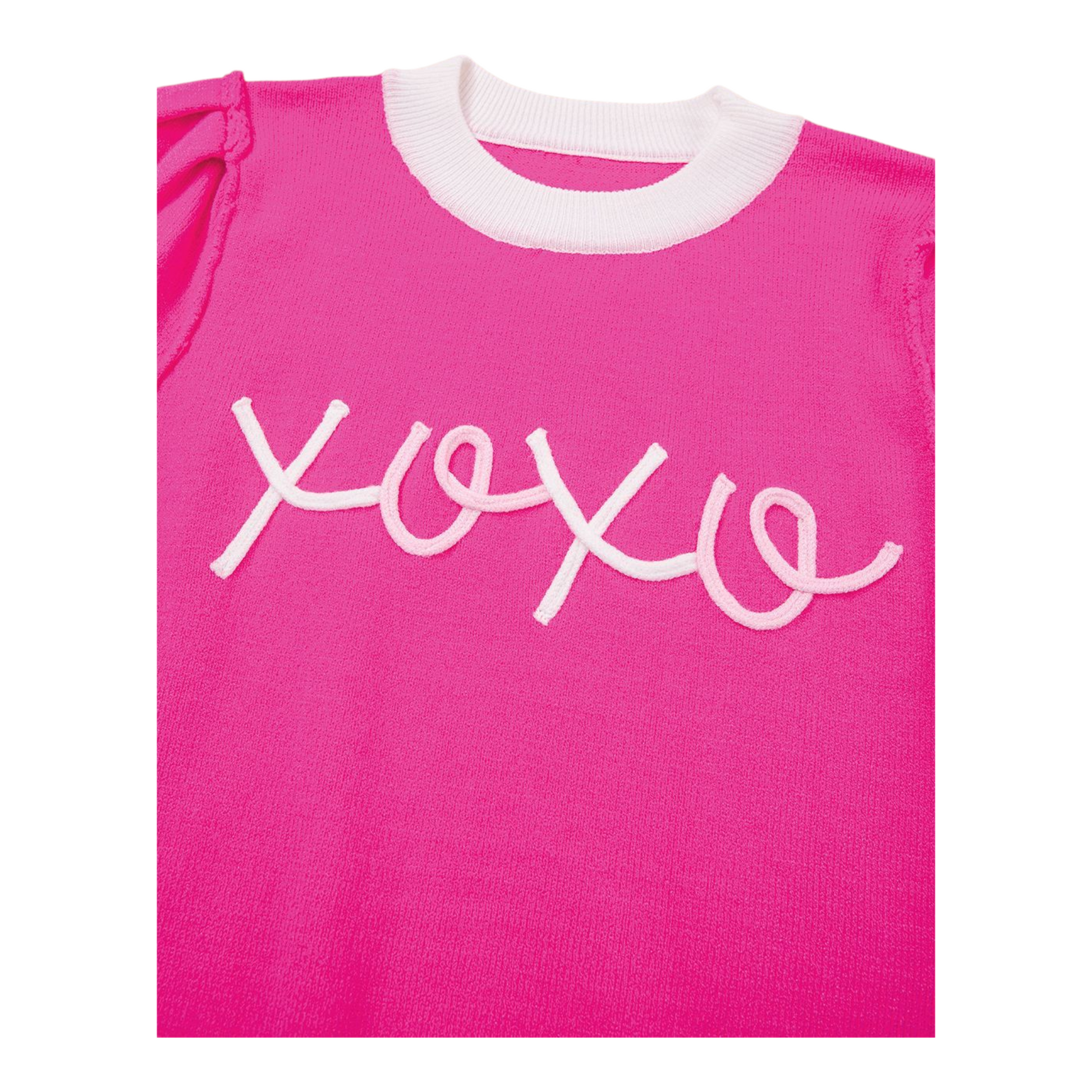 Pink shirt with white 'xoxo' text on a white background